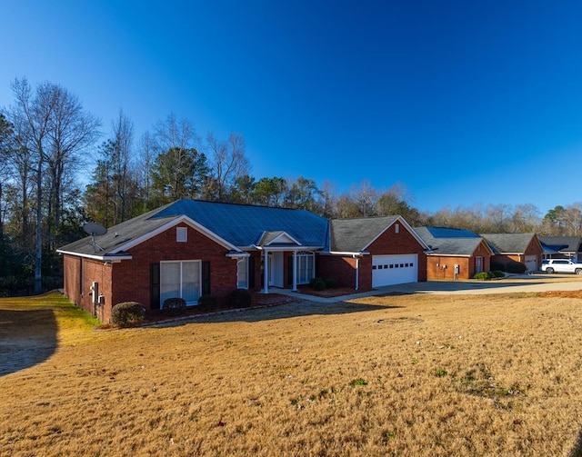 ranch-style home with a garage and a front lawn