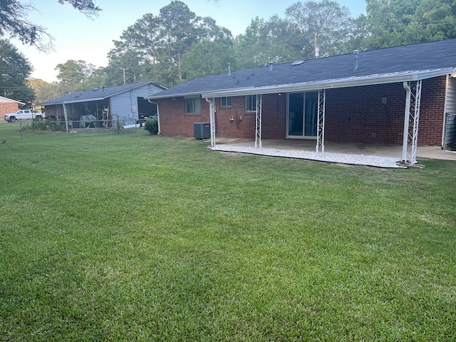 4229 Empire St, Columbus, GA 31907 - rear view of house with a patio, an attached carport, and brick siding