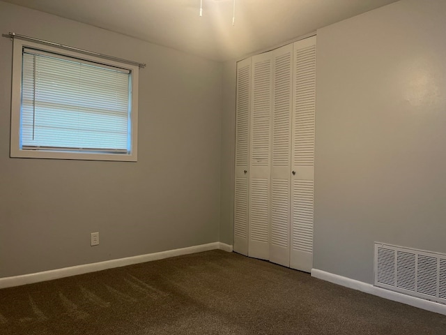 4229 Empire St, Columbus, GA 31907 - unfurnished bedroom with dark colored carpet and a closet