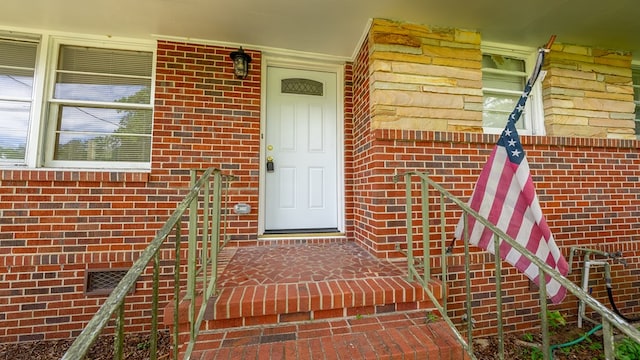 entrance to property with brick siding