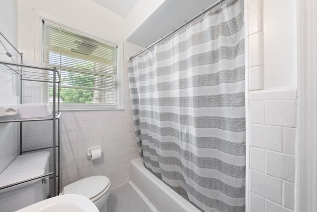 full bathroom featuring tile walls, toilet, tile patterned floors, and shower / tub combo with curtain
