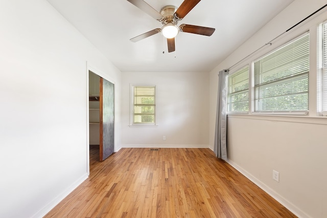 empty room featuring light wood-style floors, baseboards, and ceiling fan
