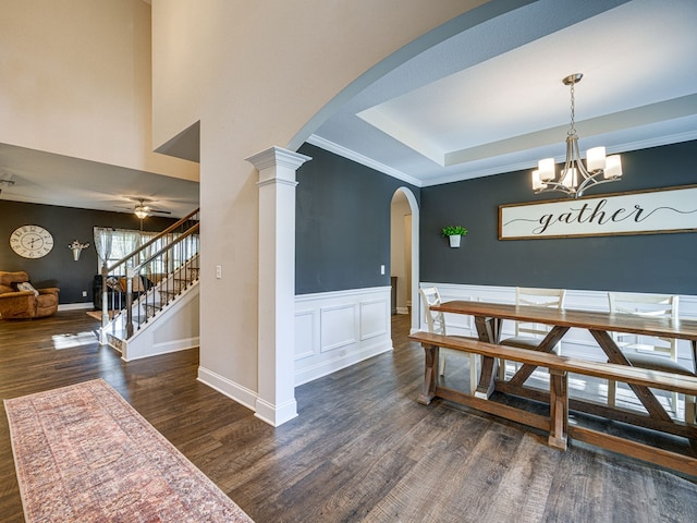 13733 Macon Rd, Upatoi, GA 31829 - dining room featuring wood finished floors, arched walkways, stairs, a chandelier, and a raised ceiling