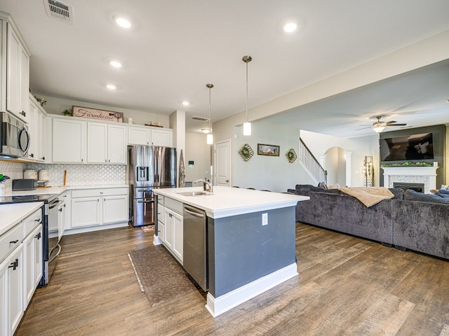 13733 Macon Rd, Upatoi, GA 31829 - kitchen featuring appliances with stainless steel finishes, ceiling fan, dark wood-style floors, open floor plan, and recessed lighting