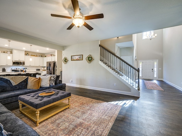 13733 Macon Rd, Upatoi, GA 31829 - living area with dark wood-style flooring, stairway, ceiling fan, and a chandelier