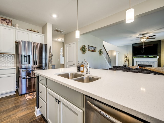 13733 Macon Rd, Upatoi, GA 31829 - kitchen with appliances with stainless steel finishes, a warm lit fireplace, a ceiling fan, hanging light fixtures, and recessed lighting