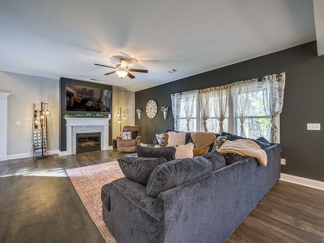 13733 Macon Rd, Upatoi, GA 31829 - living area featuring a tiled fireplace, wood finished floors, and a ceiling fan