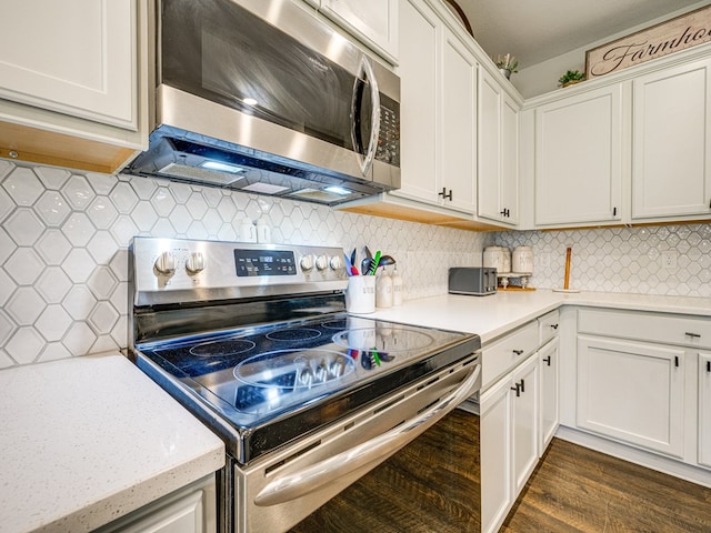 13733 Macon Rd, Upatoi, GA 31829 - kitchen with stainless steel appliances, light countertops, dark wood-style floors, and white cabinetry