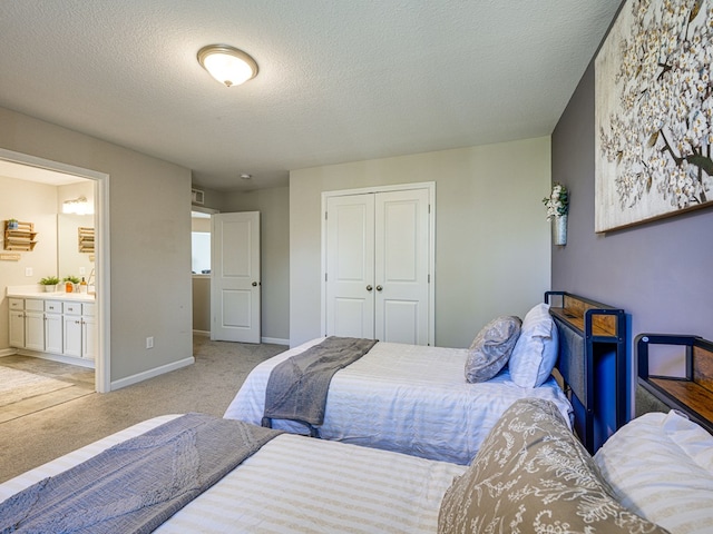 13733 Macon Rd, Upatoi, GA 31829 - bedroom featuring a closet, light carpet, a textured ceiling, and ensuite bath
