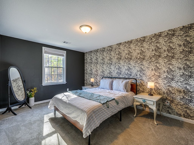 13733 Macon Rd, Upatoi, GA 31829 - carpeted bedroom featuring wallpapered walls, a textured ceiling, and an accent wall