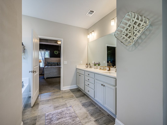 13733 Macon Rd, Upatoi, GA 31829 - ensuite bathroom with double vanity, a garden tub, and stone finish floors