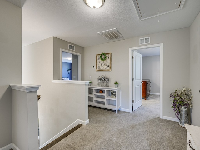 13733 Macon Rd, Upatoi, GA 31829 - hall featuring attic access, an upstairs landing, carpet, and a textured ceiling