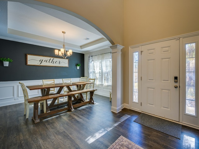 13733 Macon Rd, Upatoi, GA 31829 - entrance foyer with arched walkways, a raised ceiling, ornate columns, healthy amount of natural light, and wainscoting