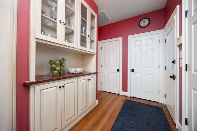 doorway to outside featuring visible vents and wood finished floors