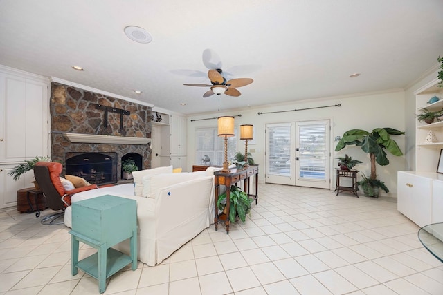 living room featuring light tile patterned flooring, a fireplace, and crown molding