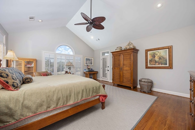 bedroom with visible vents, high vaulted ceiling, wood finished floors, baseboards, and ceiling fan