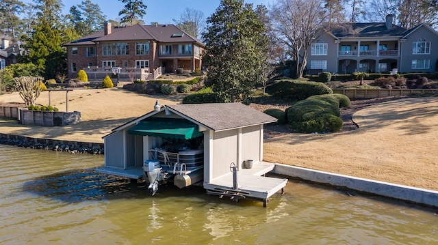 dock area with a water view and boat lift