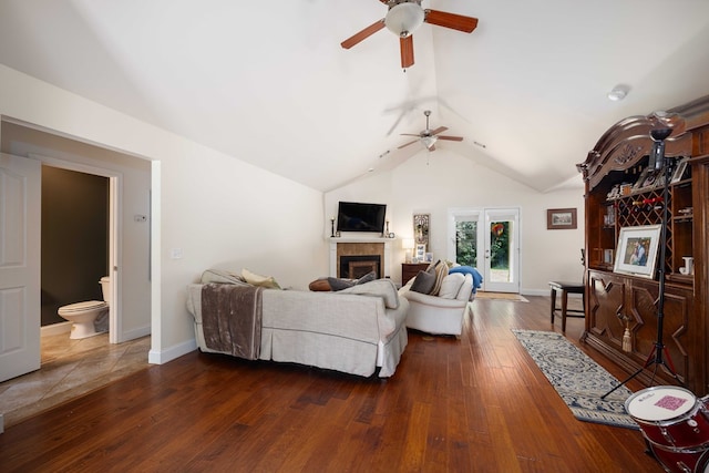 living room with ceiling fan, dark hardwood / wood-style flooring, and lofted ceiling