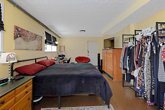 bedroom featuring concrete floors