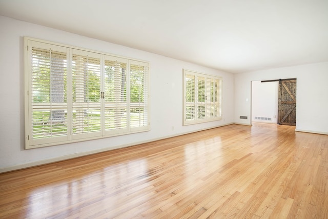 2951 Florence Dr, Columbus, GA 31907 - empty room featuring a barn door, wood finished floors, and baseboards