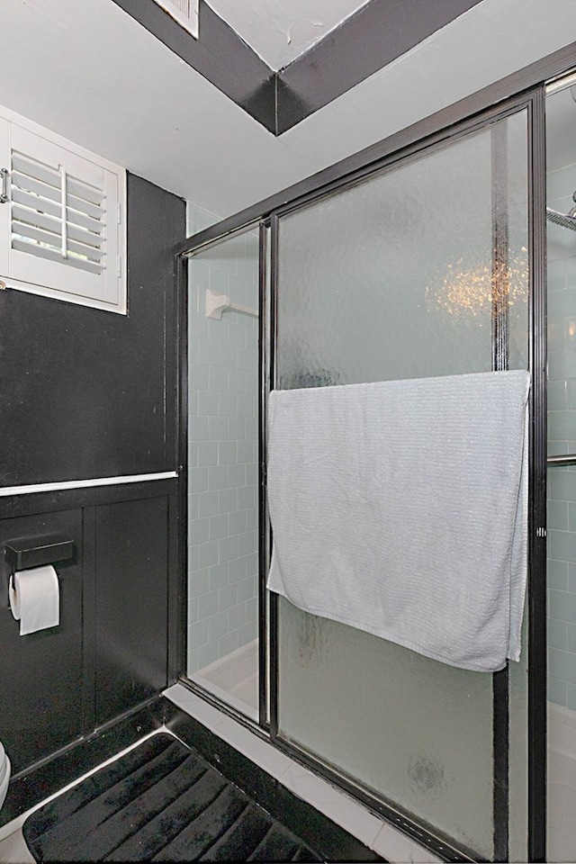 bathroom featuring a stall shower and toilet