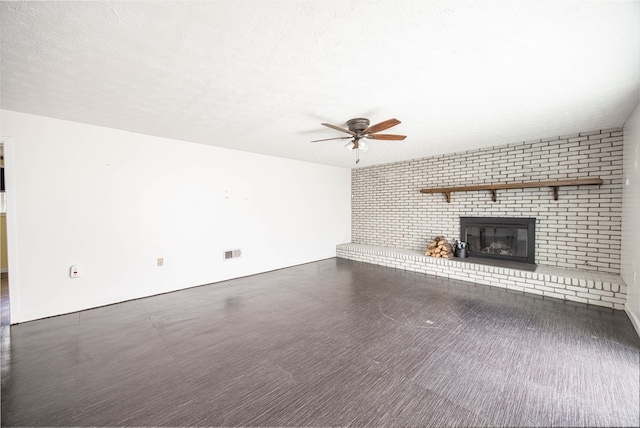 2951 Florence Dr, Columbus, GA 31907 - unfurnished living room with a ceiling fan, a fireplace, and a textured ceiling