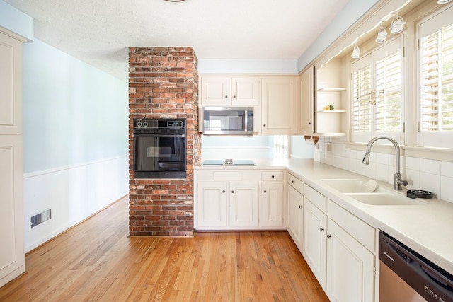 2951 Florence Dr, Columbus, GA 31907 - kitchen with black appliances, a sink, open shelves, light wood finished floors, and wainscoting