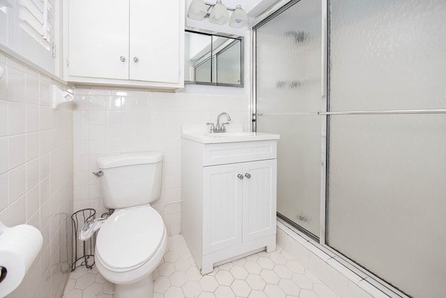 2951 Florence Dr, Columbus, GA 31907 - bathroom featuring a shower stall, vanity, toilet, tile walls, and tile patterned flooring