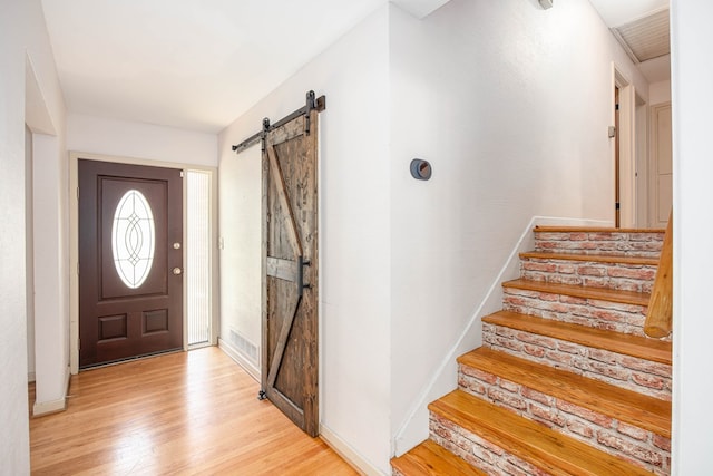 2951 Florence Dr, Columbus, GA 31907 - entryway with a barn door, light wood-style floors, stairway, and baseboards