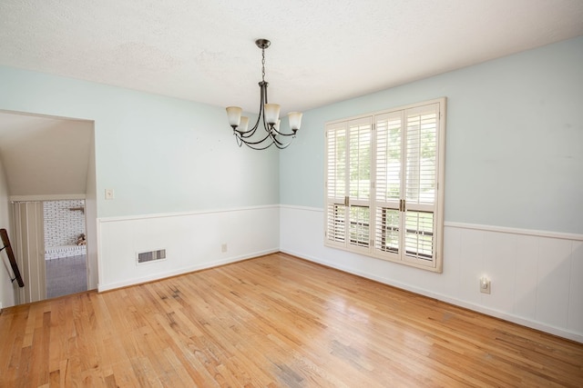 2951 Florence Dr, Columbus, GA 31907 - empty room with wood finished floors, a chandelier, and wainscoting