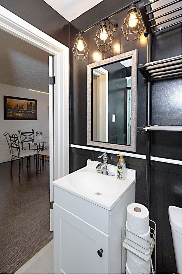 bathroom featuring toilet and vanity