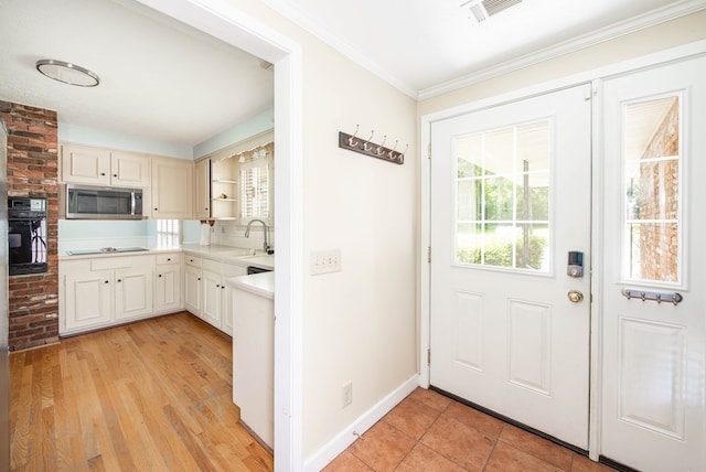 2951 Florence Dr, Columbus, GA 31907 - kitchen with black appliances, open shelves, light countertops, a sink, and crown molding