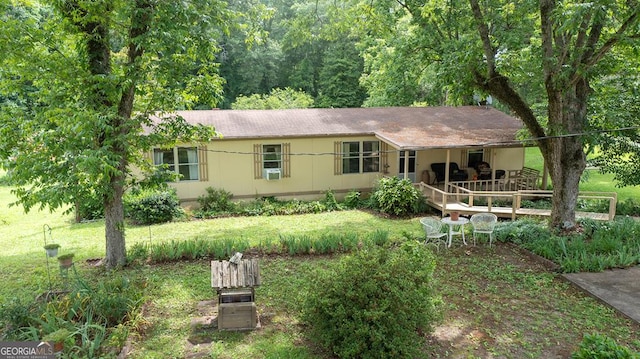 view of front of house with a front lawn and a deck