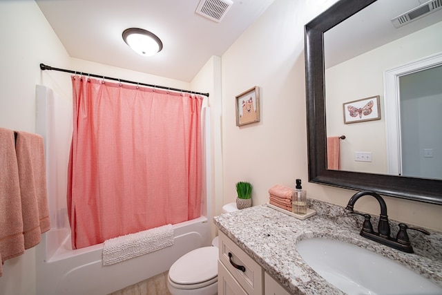 full bathroom with vanity, shower / tub combo with curtain, and toilet