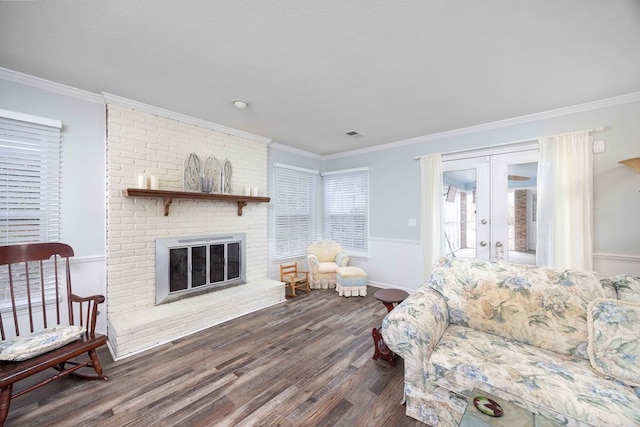 living room featuring a brick fireplace, a textured ceiling, dark hardwood / wood-style flooring, french doors, and ornamental molding