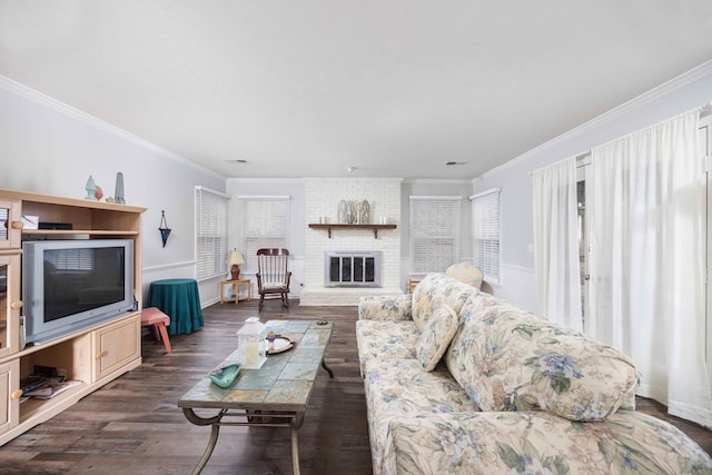 living room featuring a fireplace, ornamental molding, and dark wood-type flooring