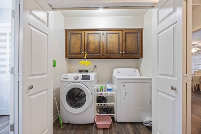 laundry area featuring separate washer and dryer, dark hardwood / wood-style floors, and cabinets