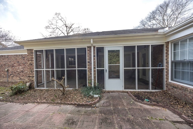 exterior space with a patio and a sunroom