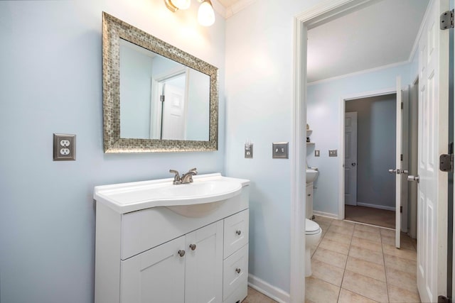 bathroom featuring toilet, vanity, tile patterned flooring, and crown molding