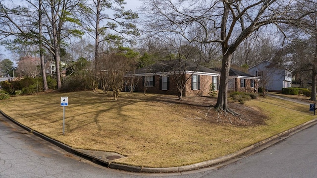 ranch-style house featuring a front lawn