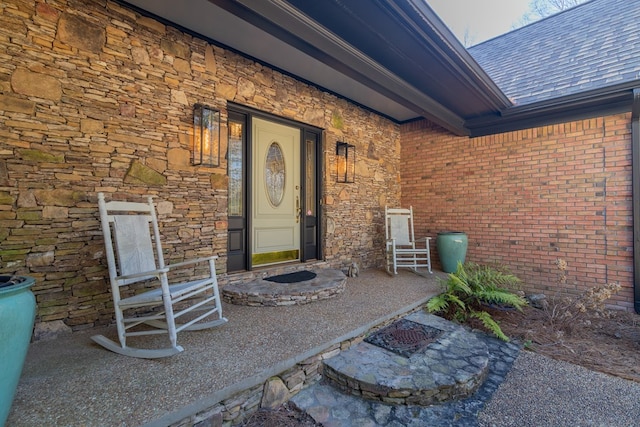 doorway to property with brick siding and stone siding