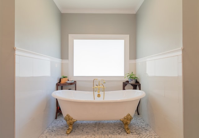 full bath with crown molding, tile walls, wainscoting, and a freestanding bath