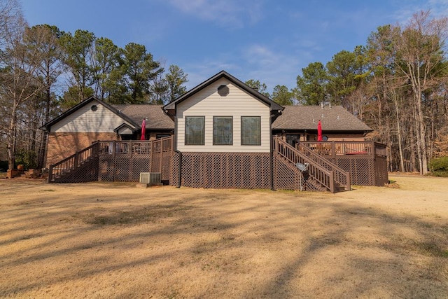 back of house with stairs, a deck, a yard, and central AC