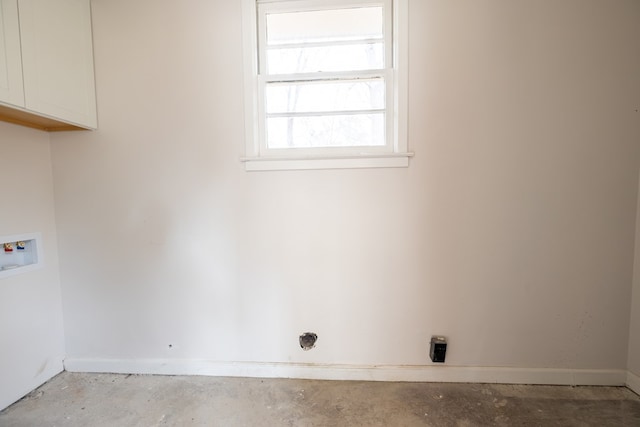 laundry area featuring hookup for a washing machine, cabinet space, and baseboards