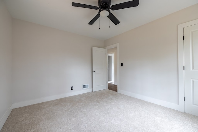 interior space with carpet floors, a ceiling fan, visible vents, and baseboards