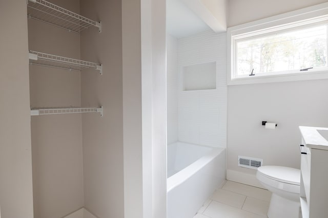 bathroom with toilet, visible vents, baseboards, vanity, and tile patterned floors