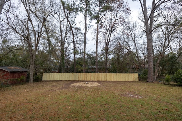 view of yard with an outbuilding and fence