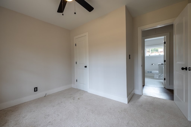 unfurnished bedroom with carpet, a closet, ceiling fan, and baseboards