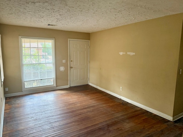 interior space with dark hardwood / wood-style flooring and a textured ceiling