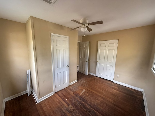 unfurnished bedroom featuring dark wood-type flooring and ceiling fan